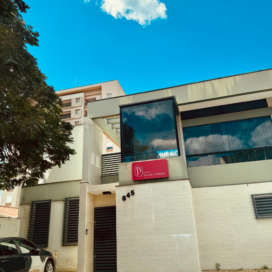 Um prédio branco com uma placa vermelha que diz p nele