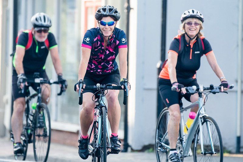 3 cyclists smiling