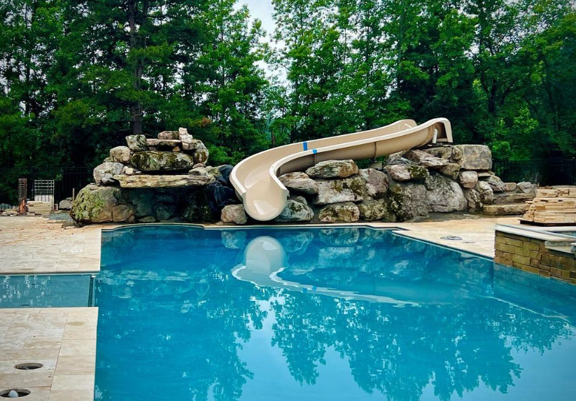  water slide in the middle of Residential inground pool designed and installed by Carolina Pool Plastering in Pineville, NC