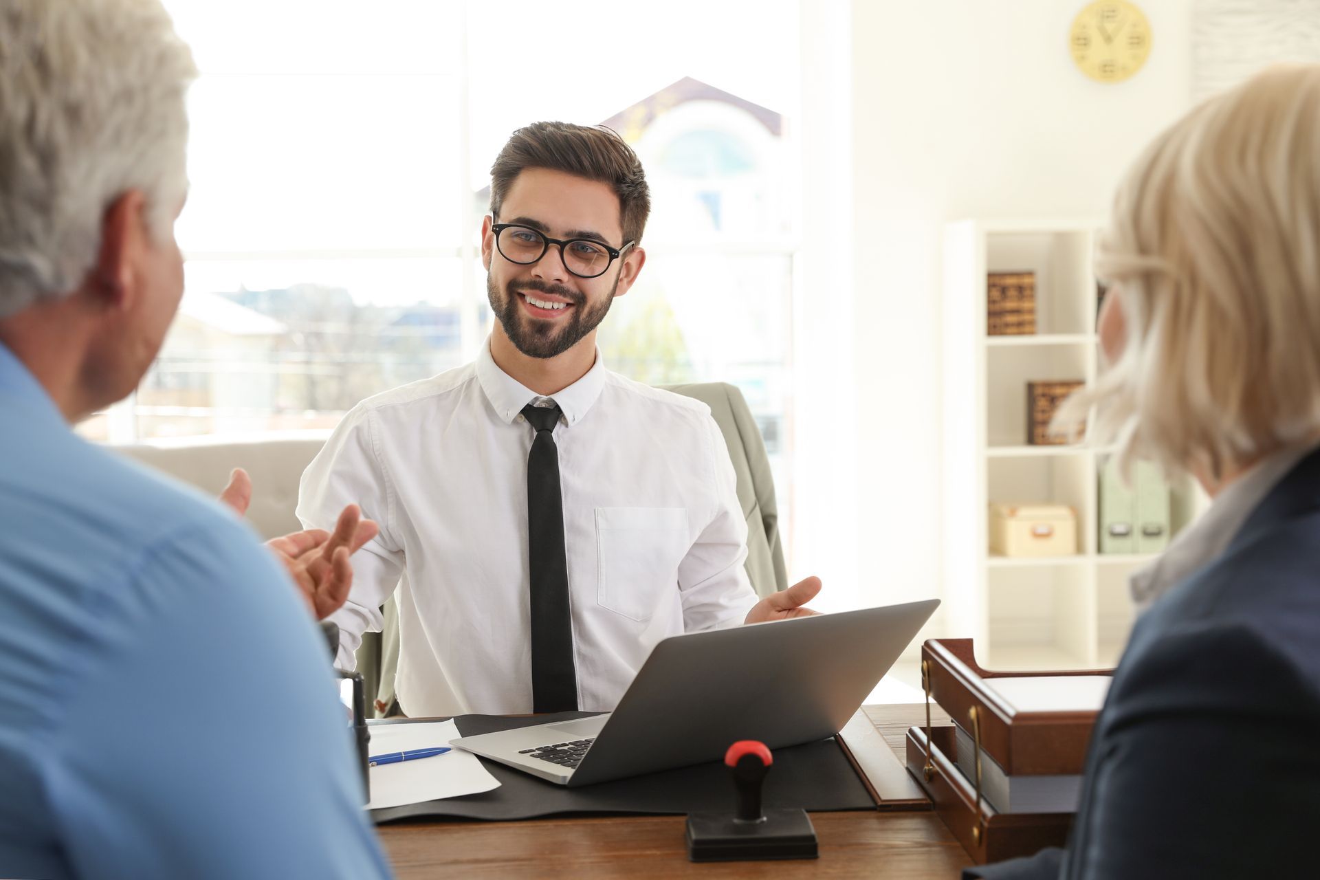 Male notary working with mature couple in office.