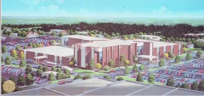 Architectural rendering of a large, multi-story brick building with extensive parking, set amidst trees.
