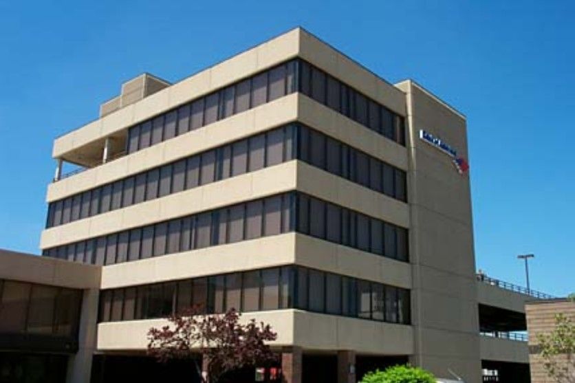 Bank of America building with five stories, tan exterior, and large windows.