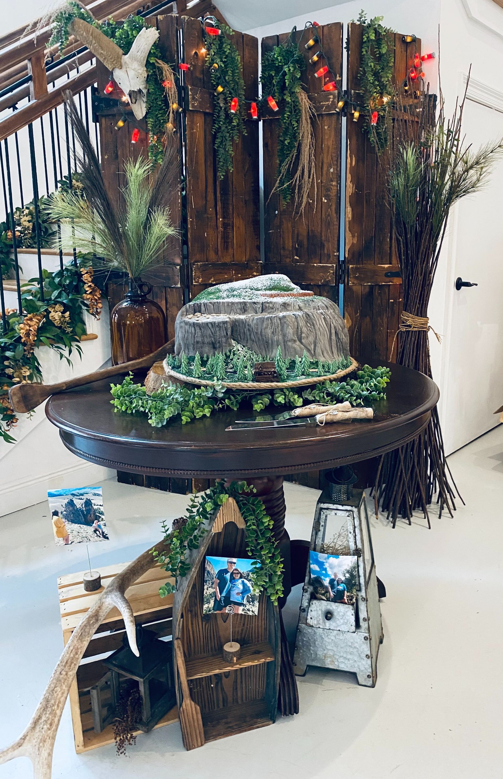 Decorative indoor fountain with plants, wooden backdrop, and holiday garland display