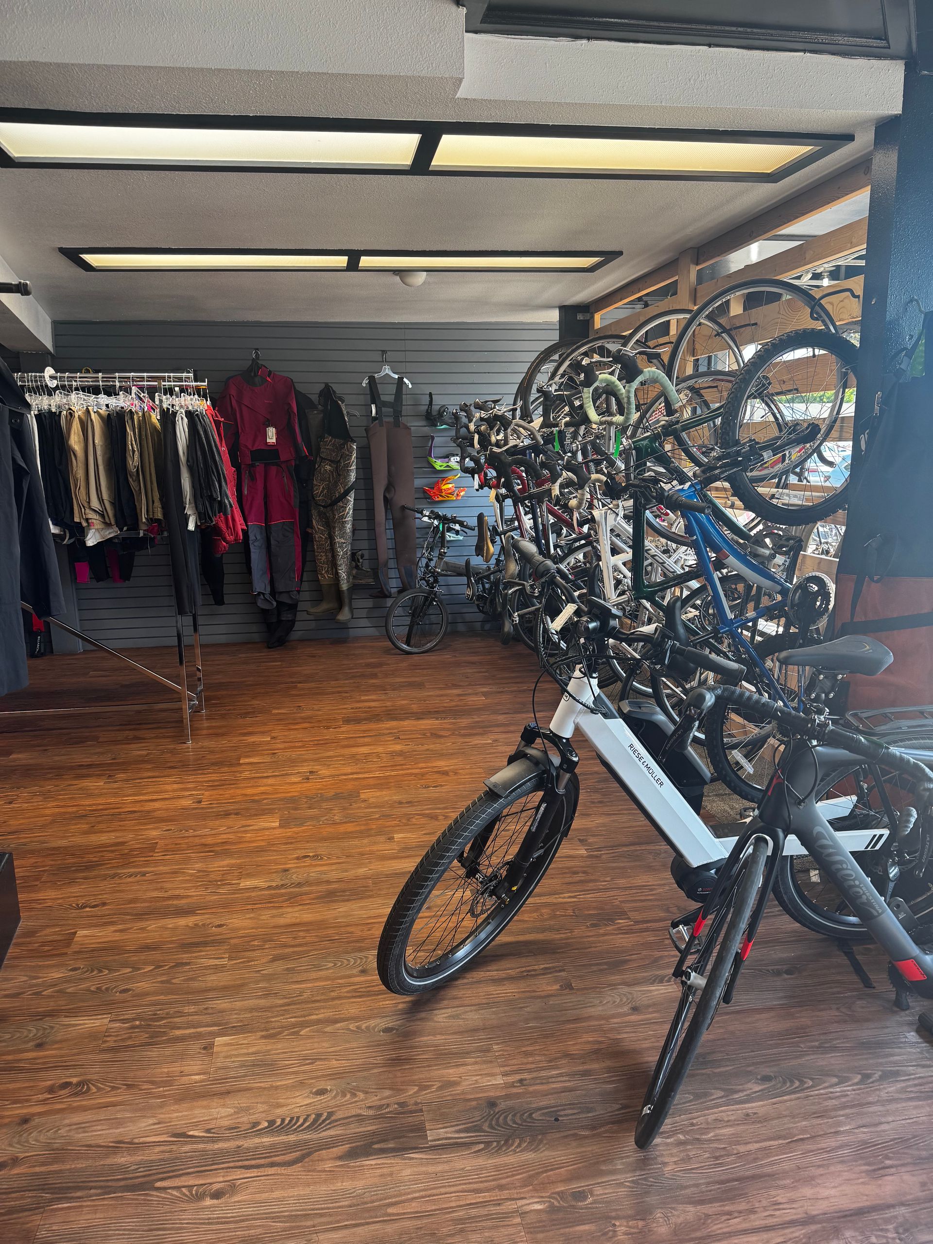 A row of bicycles are lined up in a store.