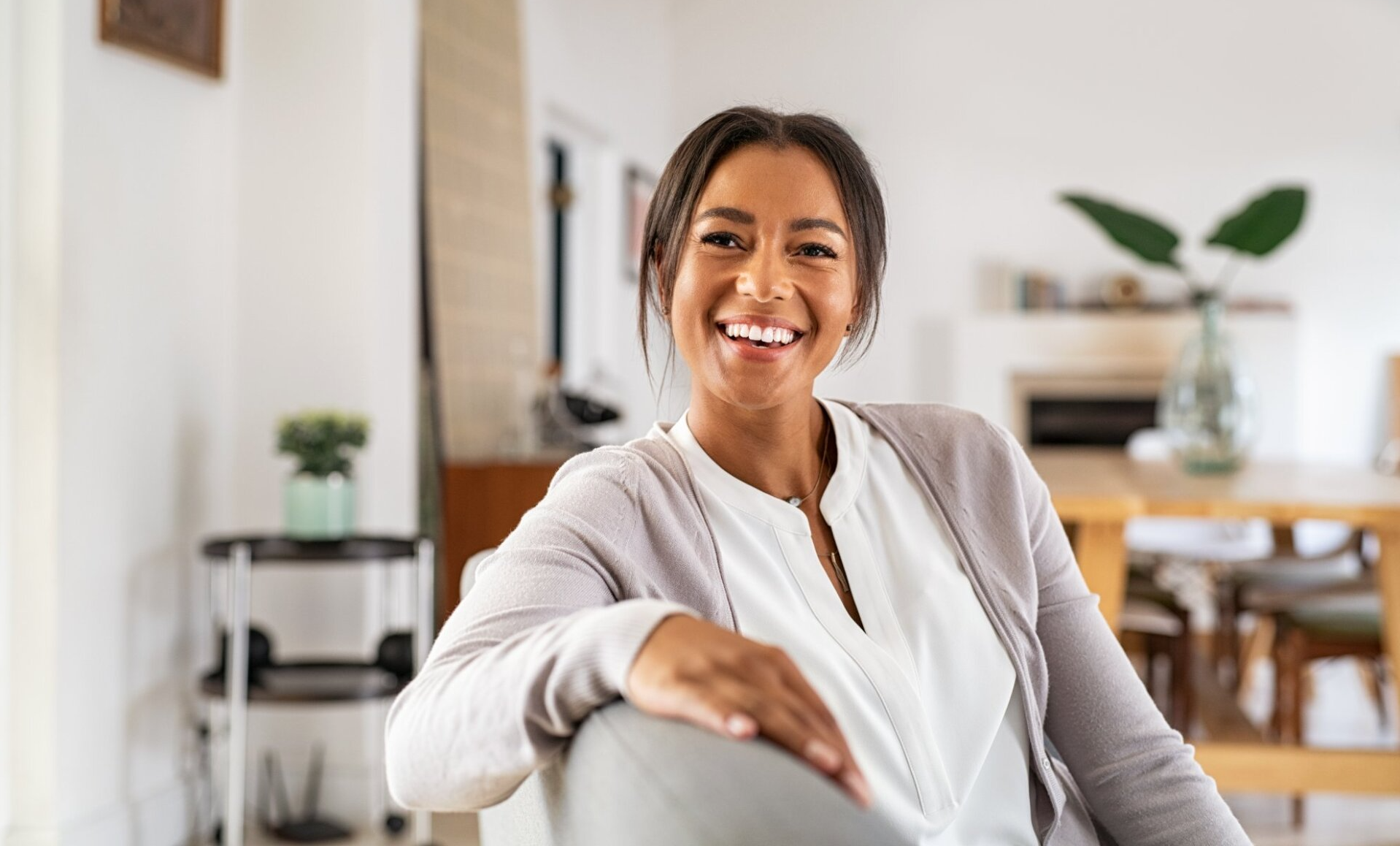 smiling woman in her 40s relaxes at home