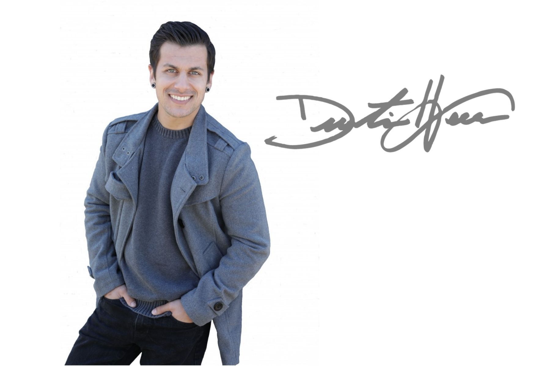 A man in a grey coat is standing in front of a signature