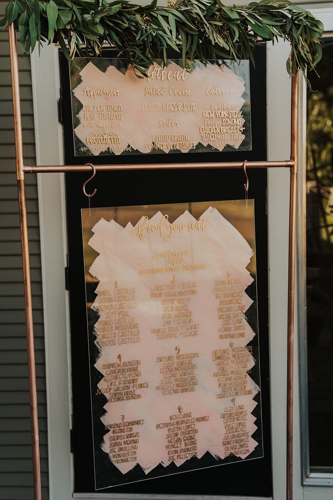A seating chart is hanging on a rack on a door.