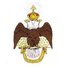 Double-headed eagle with a crown, a triangle, and the words