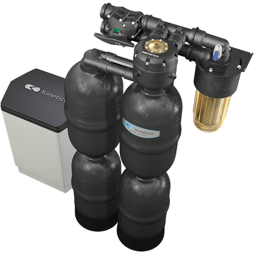 Water filtration system with multiple black tanks and a clear filter. White and black storage tank is present.