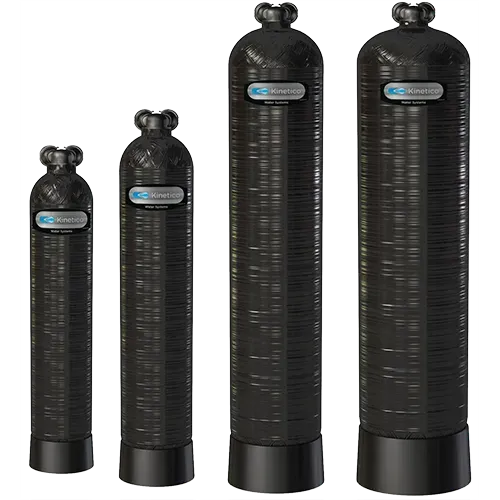 Four black water filtration tanks of varying heights.