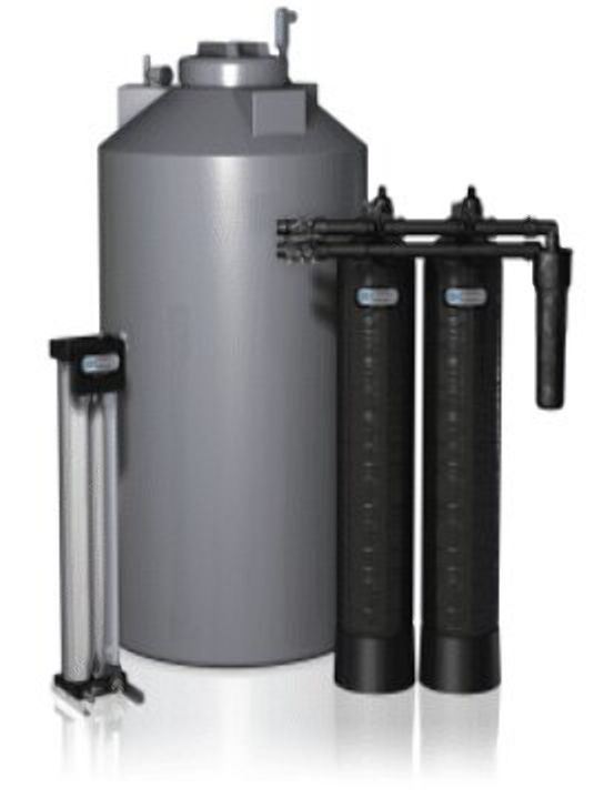 Water filtration system with a large gray tank, two black filter tanks, and a clear pre-filter.