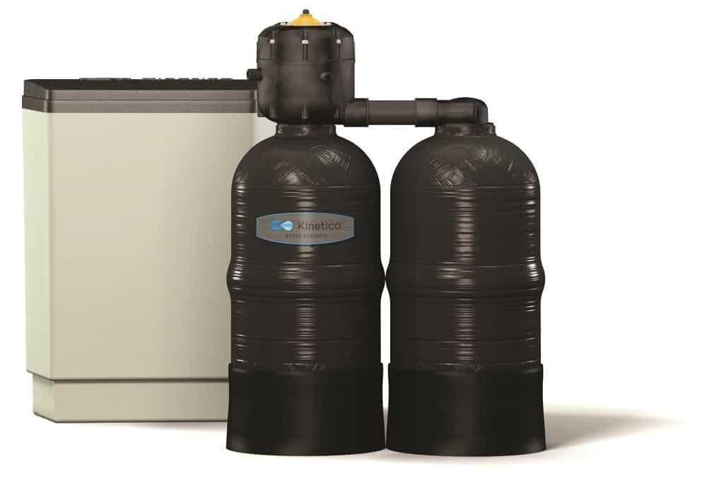 Water softening system with three black cylindrical tanks and a beige rectangular salt storage unit.