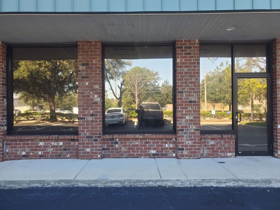 A white limousine is parked in a garage next to a sign that says pioneer