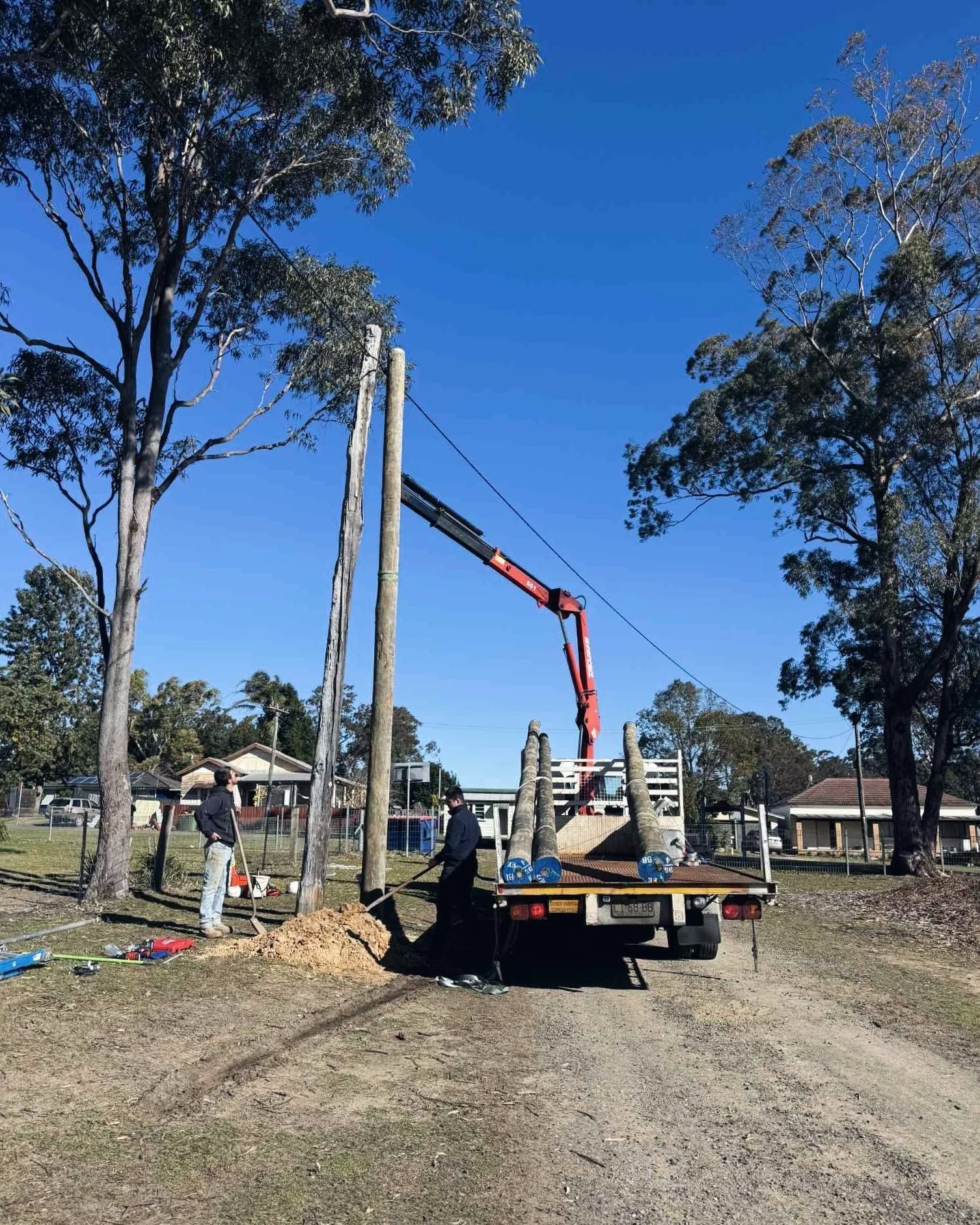 Truck-Mounted Crane Lifting a Tall Utility Pole — DMP Electrical Contractors In Hunter Valley, NSW