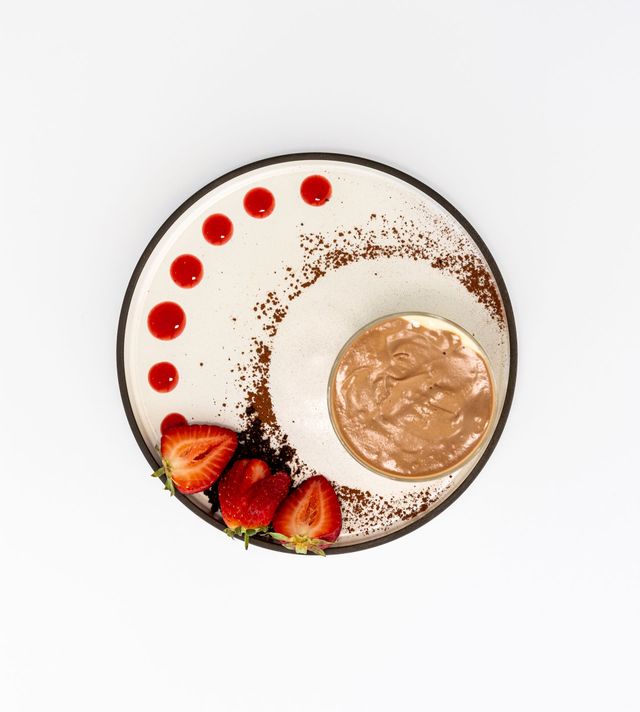Chocolate mousse dessert with strawberries and sauce on a plate — Jack West Photography In Kawungan, QLD
