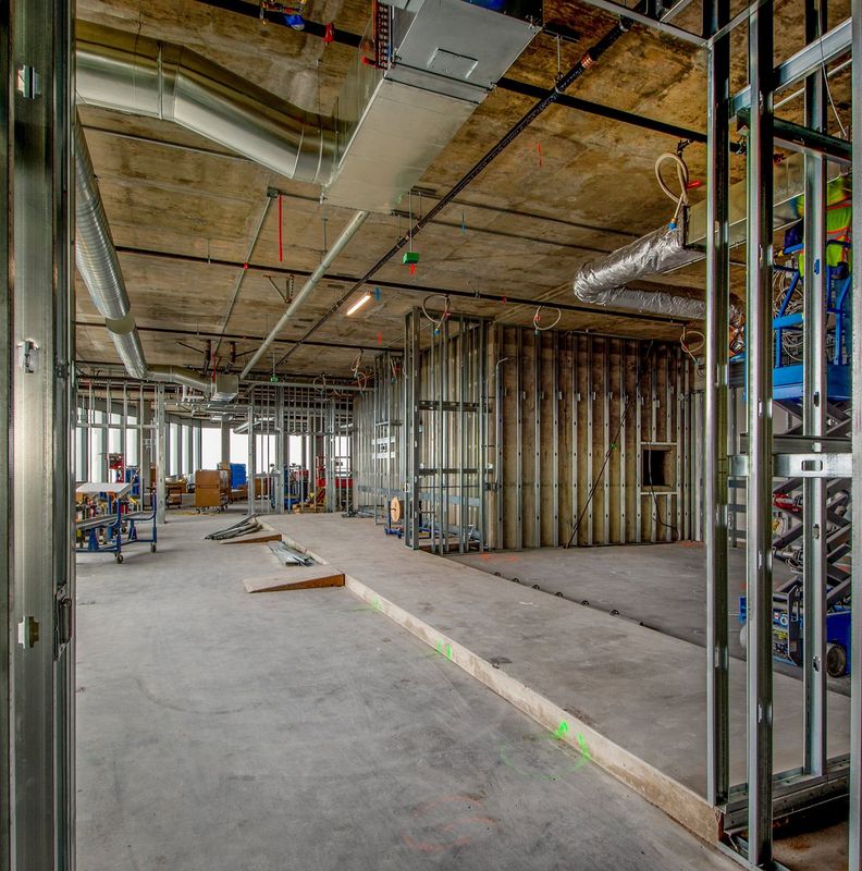 Commercial renovation interior with metal stud framing and partial drywall