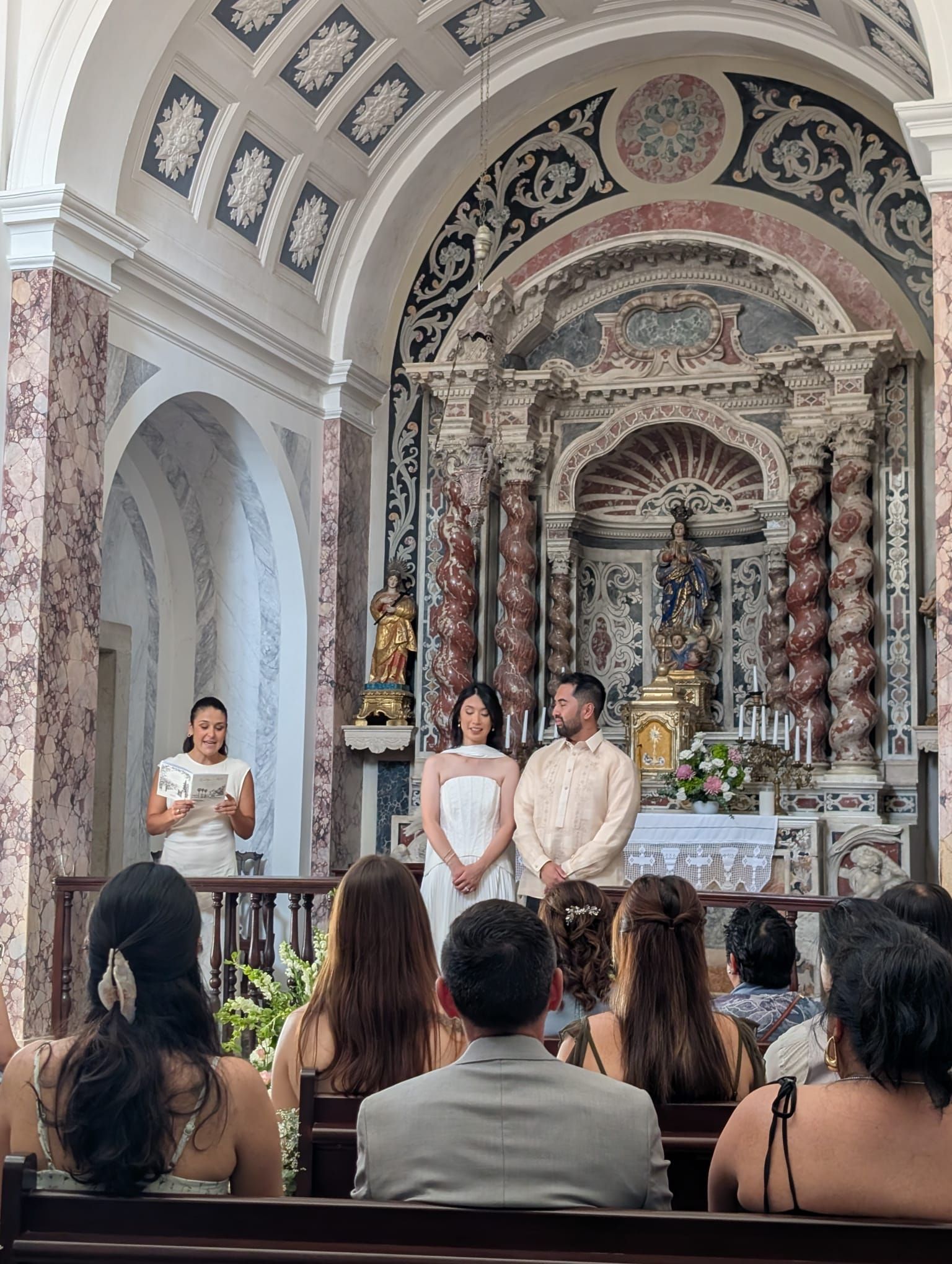 Kaitlyn and Matt celebrating their intimate wedding in the chapel at Vila Galé Collection Palácio dos Arcos