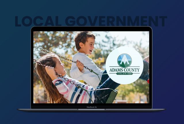 A laptop with a picture of a woman and a child on a swing.