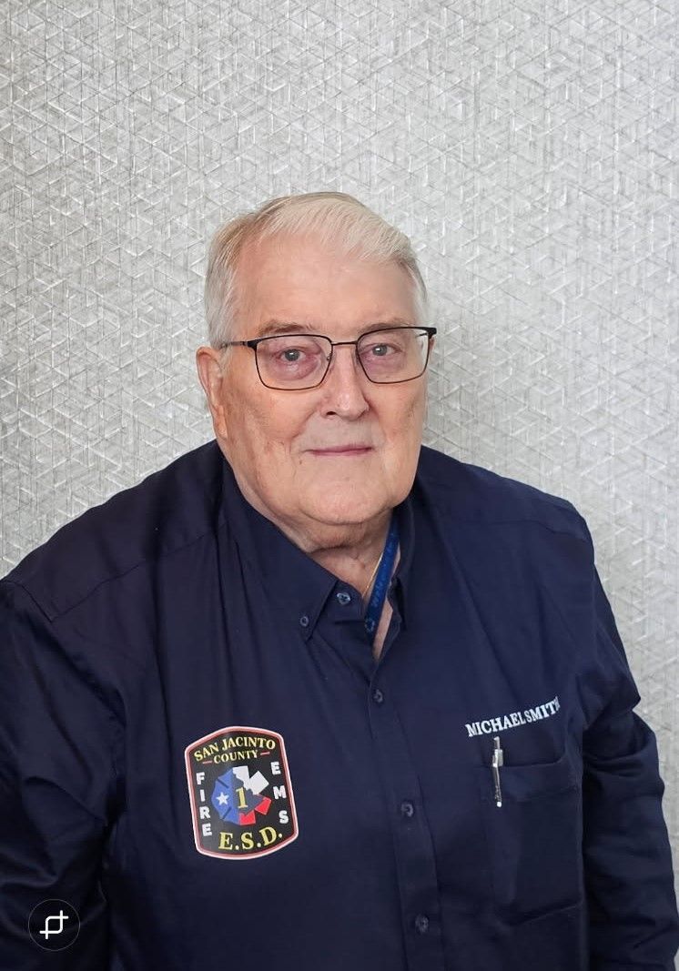 A picture of Commissioner Michael Smith and he is wearing glasses and a blue shirt with the San Jacinto ESD patch.