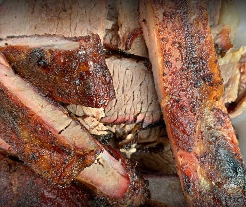 Close-up of sliced roasted meat with crispy browned edges and pink center