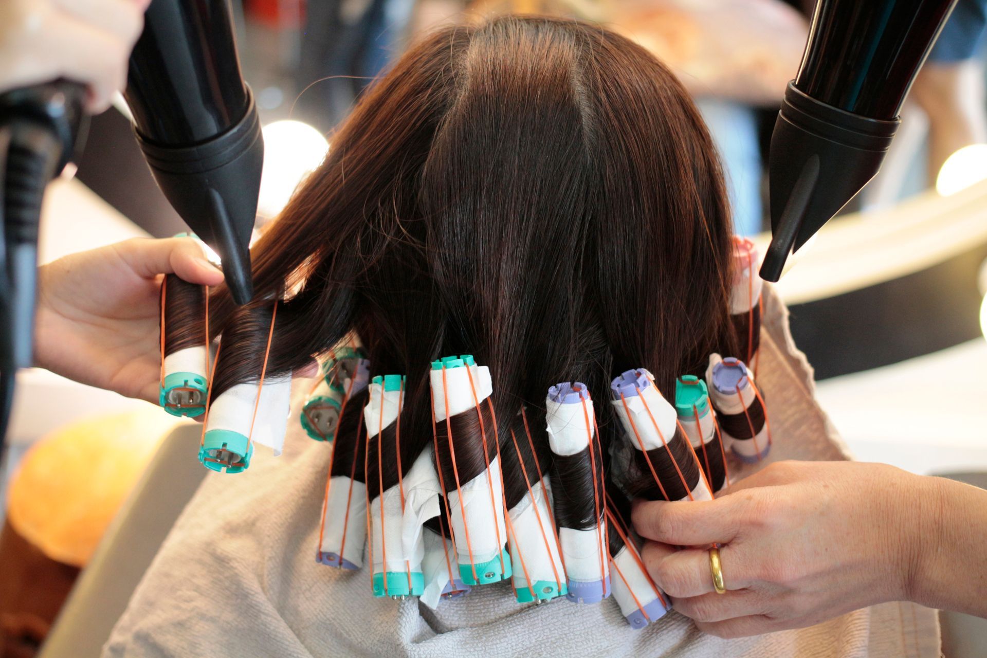 A Woman is Getting Her Hair Blow Dried in a Salon
