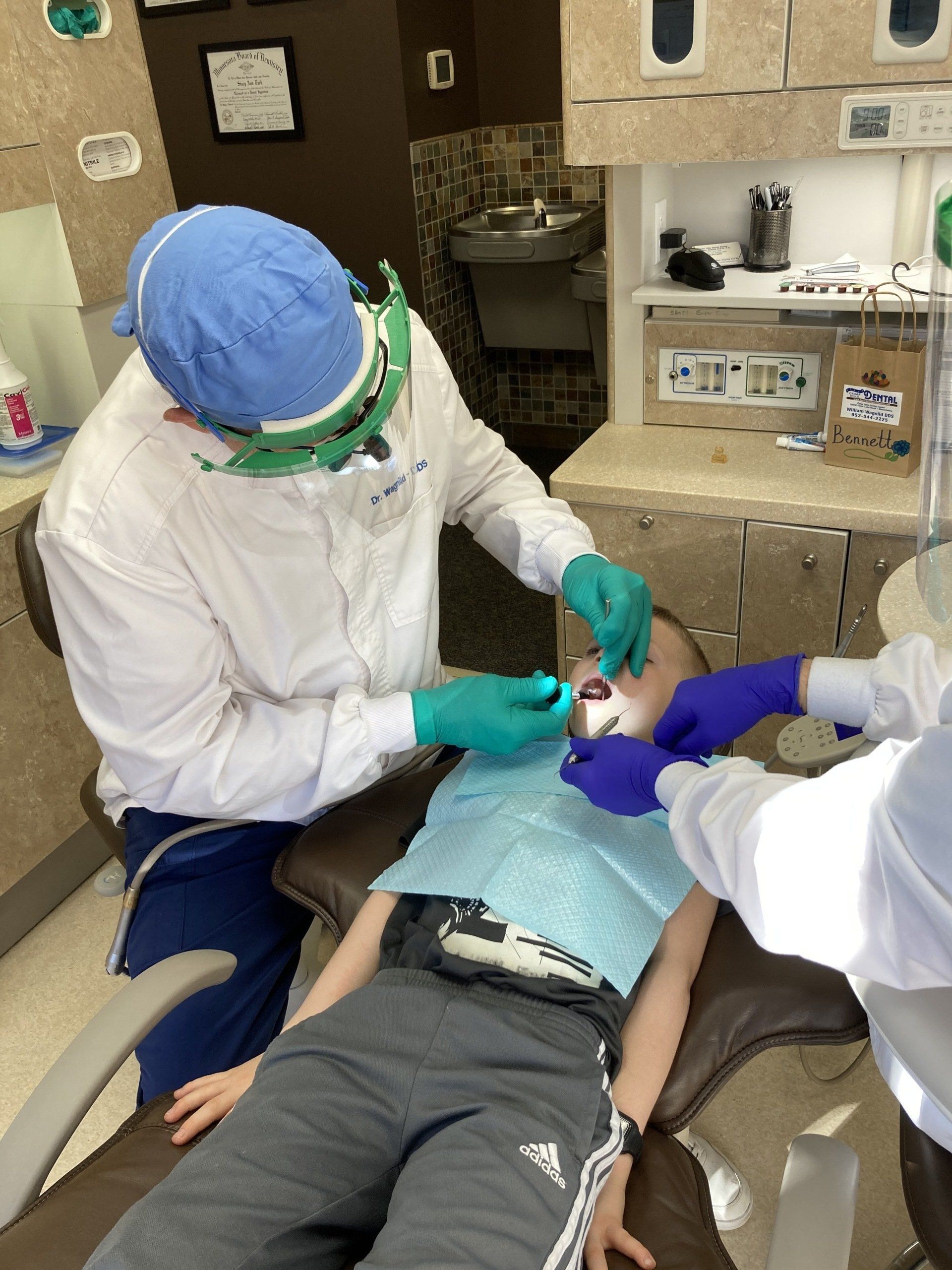 Dentist Looking at an X-Ray with His Young Patient — Minnetonka, MN — Cendar Hill Dental Center Dentist Looking at an X-Ray with His Young Patient — Minnetonka, MN — Cendar Hill Dental Center