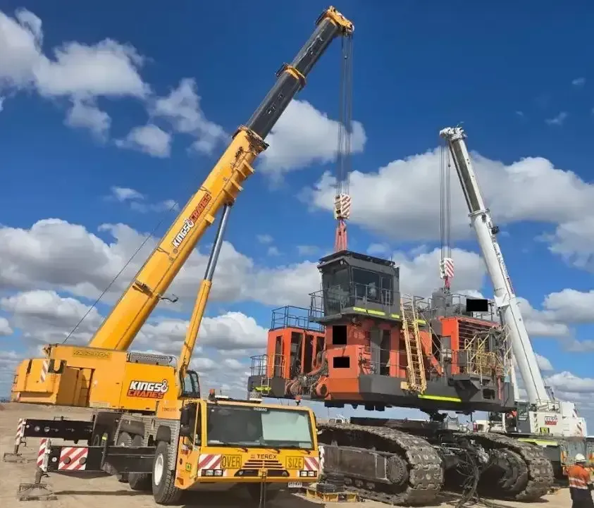 Two Cranes Lifting a Large Orange Industrial Machine — Kings Cranes in Gregory River, QLD