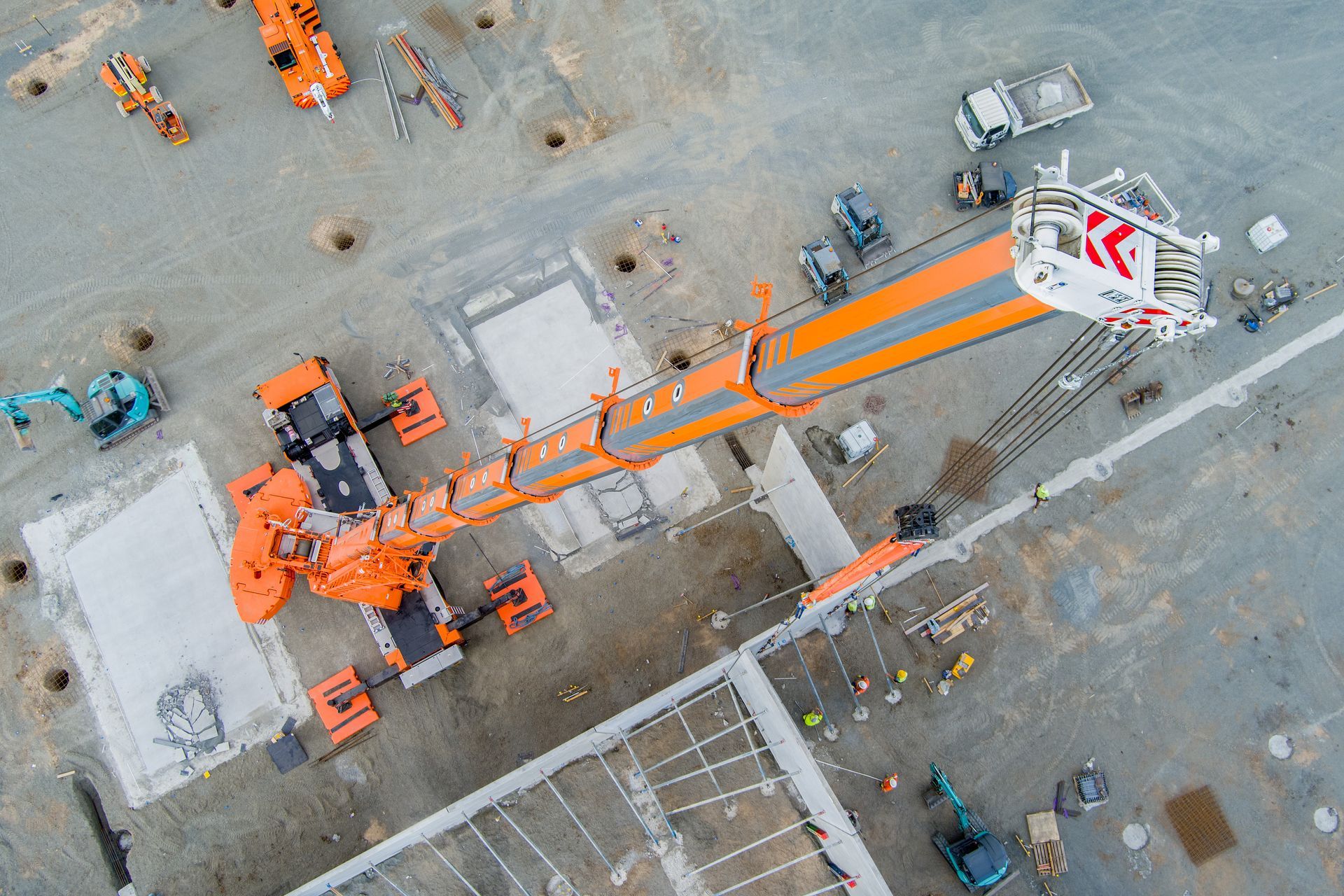 An Aerial View Of A Construction Site With A Large Orange Crane — Dynamic Crane Hire In Emerald, QLD