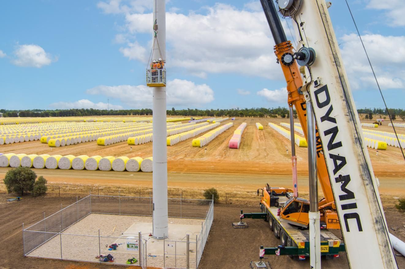 A Large Crane Is Lifting A Wind Turbine In A Field — Dynamic Crane Hire In Emerald, QLD