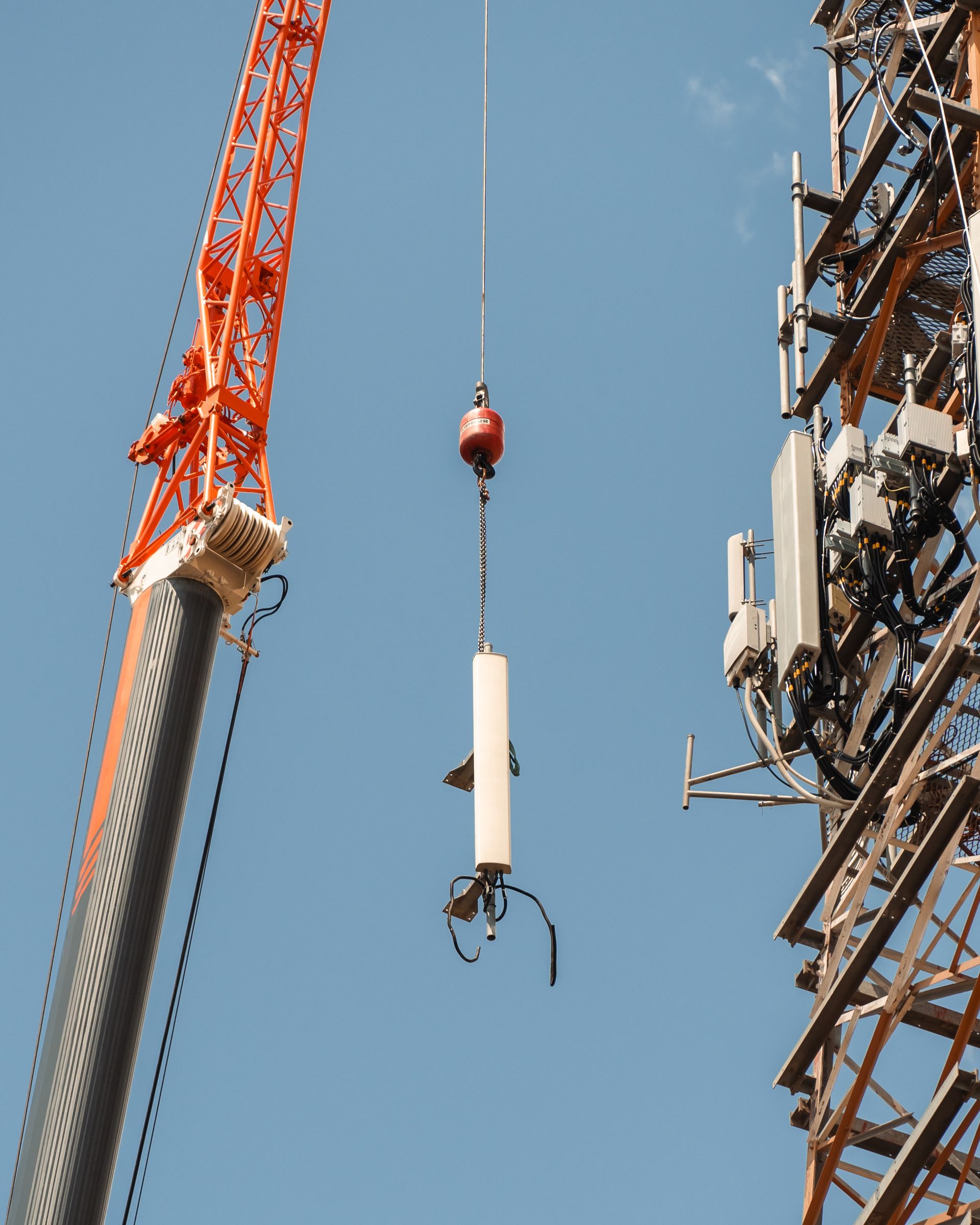 A Crane Is Lifting A White Object In The Air — Dynamic Crane Hire In Emerald, QLD