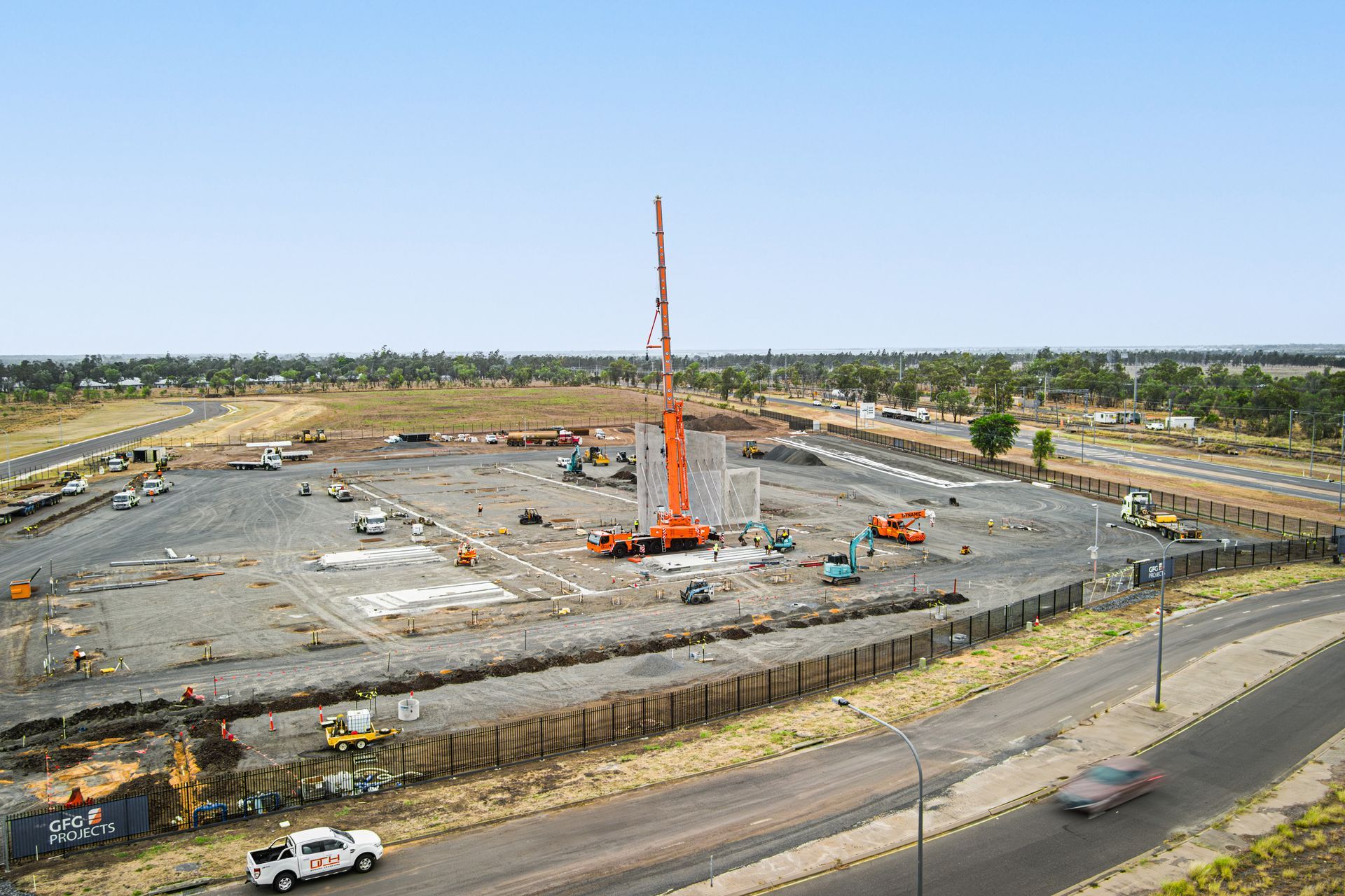 An Aerial View Of A Construction Site With A Large Orange Crane — Dynamic Crane Hire In Emerald, QLD