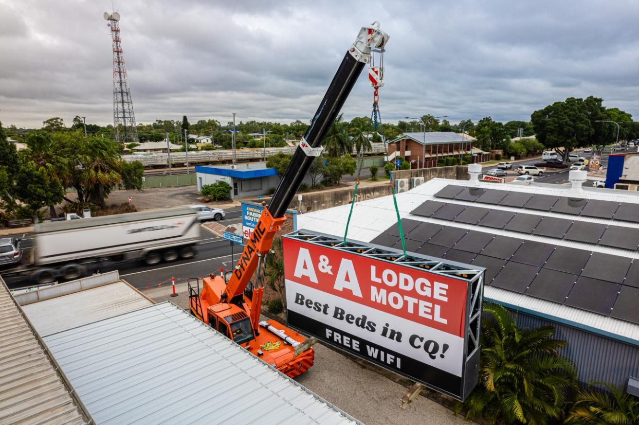 A Crane Is Lifting A Billboard For A & A Lodge Motel — Dynamic Crane Hire In Emerald, QLD