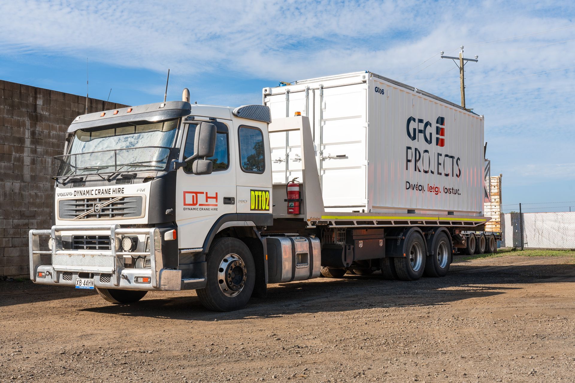 White semi-truck with a container labeled 