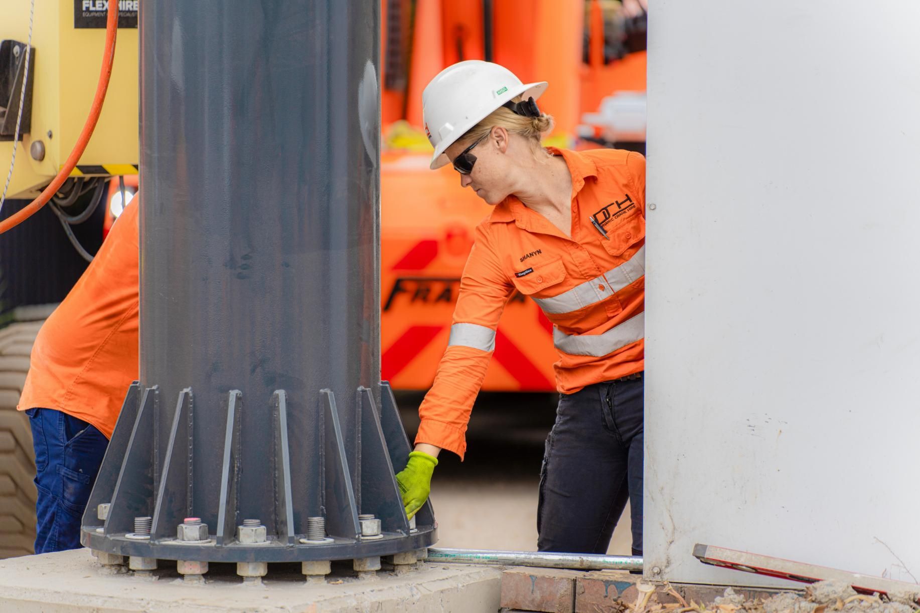 A Crane Worker Tightening Bolts at the base of a Crane — Dynamic Crane Hire In Emerald, QLD