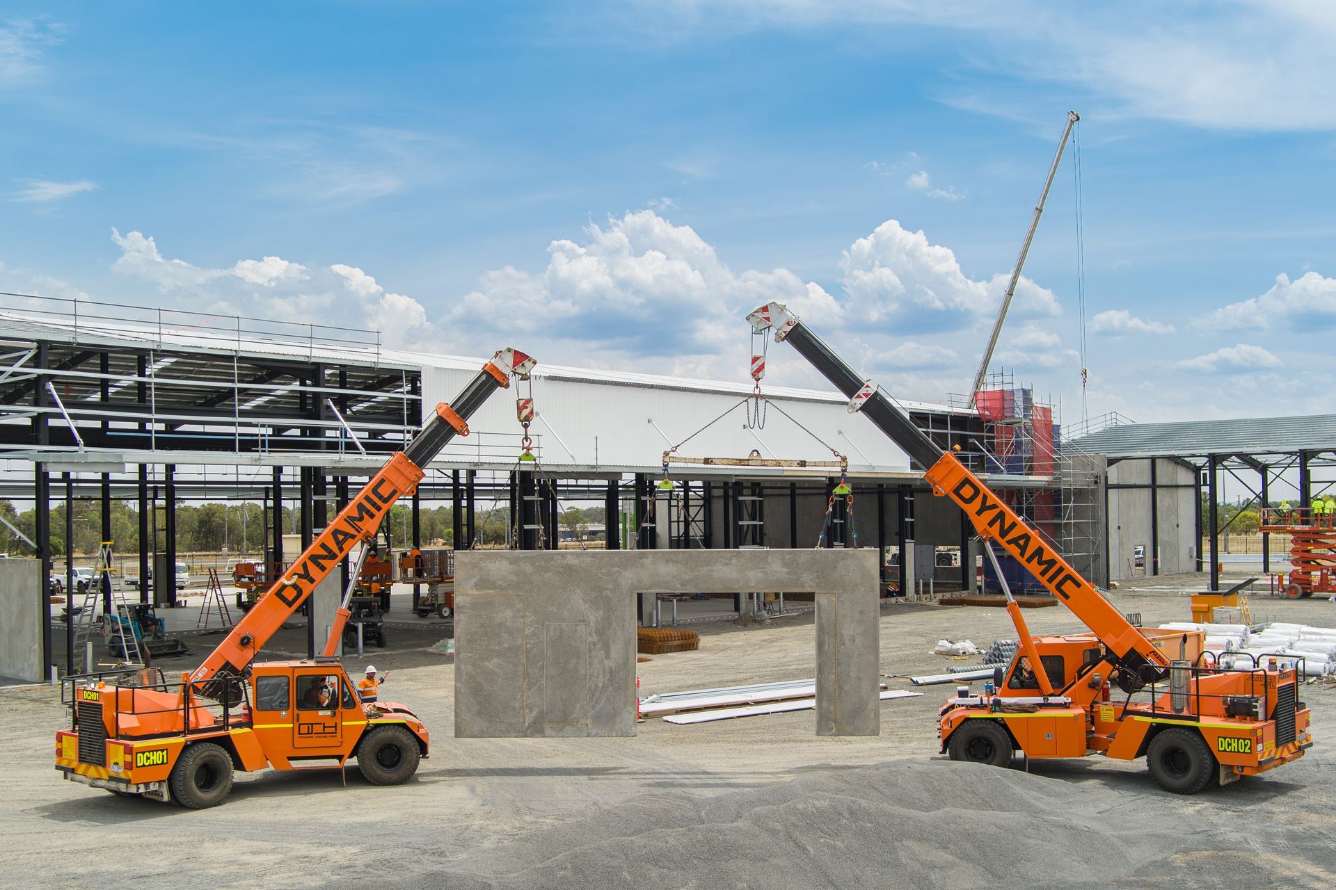 Two Dynare Trucks Are Working On A Construction Site — Dynamic Crane Hire In Emerald, QLD