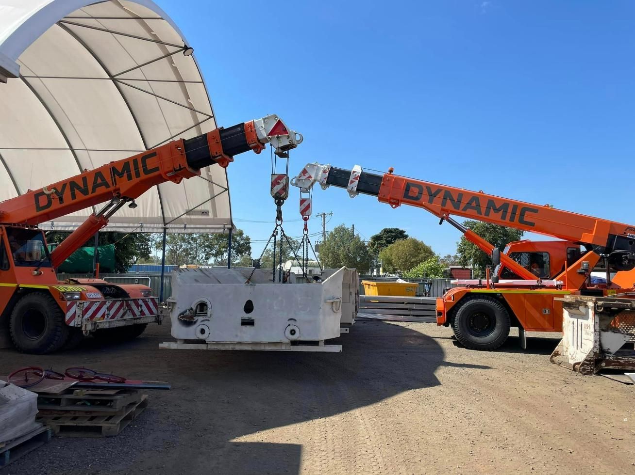 Two Orange Trucks With Dynamic Written On Them — Dynamic Crane Hire In Emerald, QLD
