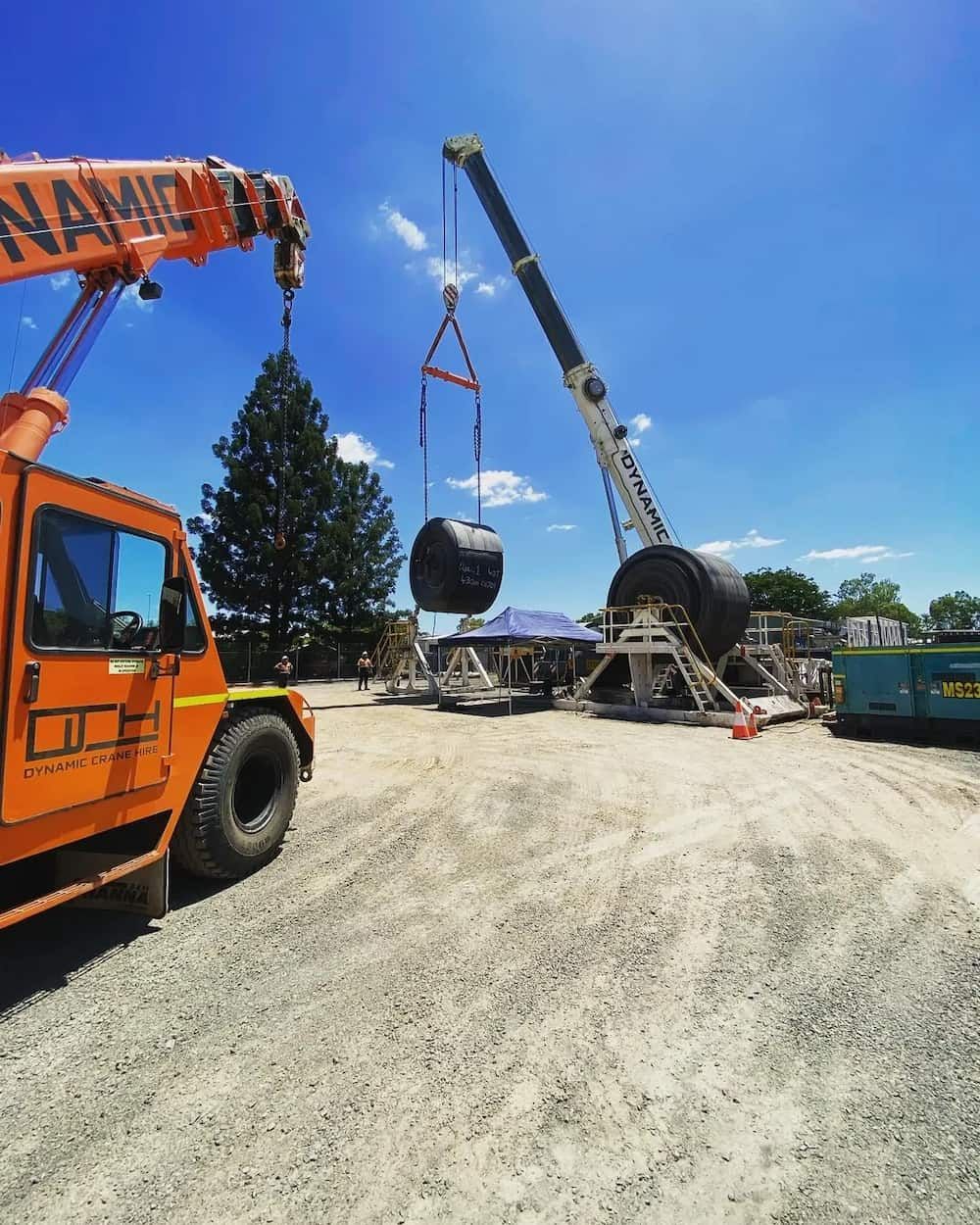 A Large Orange Crane Is Lifting A Large Object — Dynamic Crane Hire In Clermont, QLD