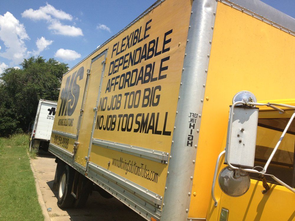 Yellow moving truck with large ad reading “Flexible, dependable, affordable, just too big, or too small”