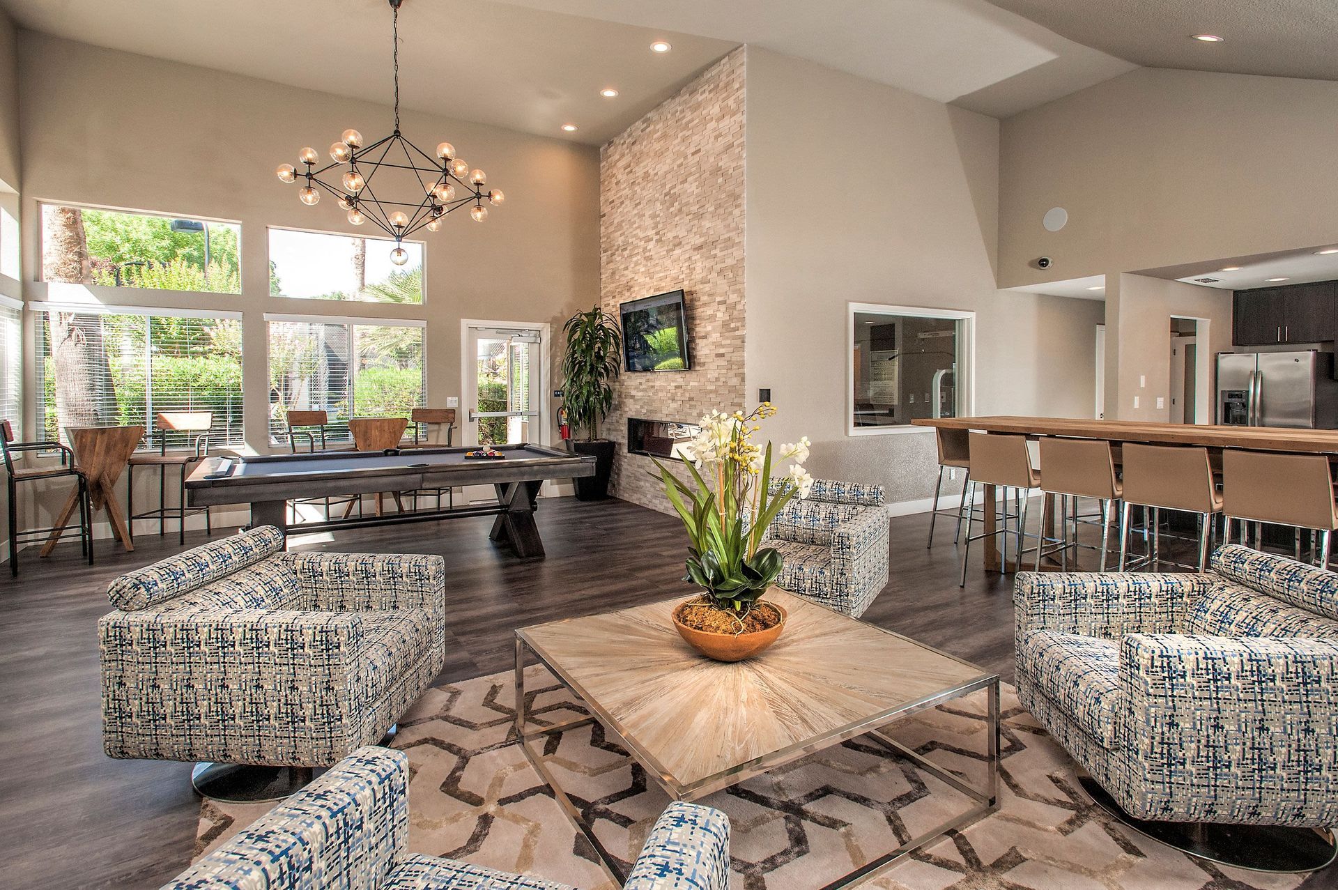 Interior community lounge with seating, a billiards table, and a kitchenette area at Shore Park at Riverlake at Shore Park at Riverlake.