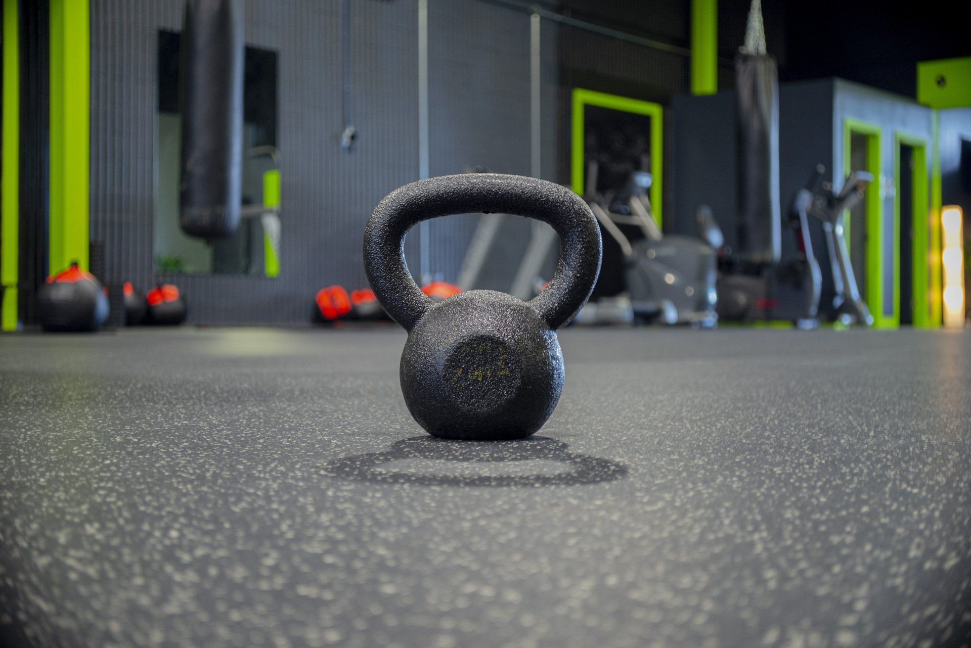 a kettlebell is sitting on the floor in a gym .