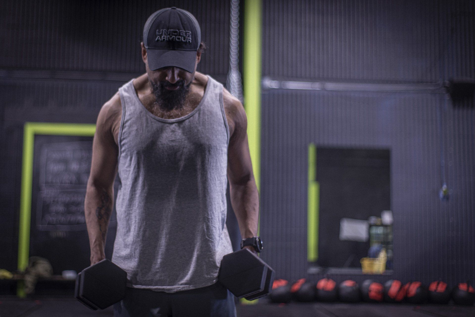 a man is lifting a dumbbell in a gym .