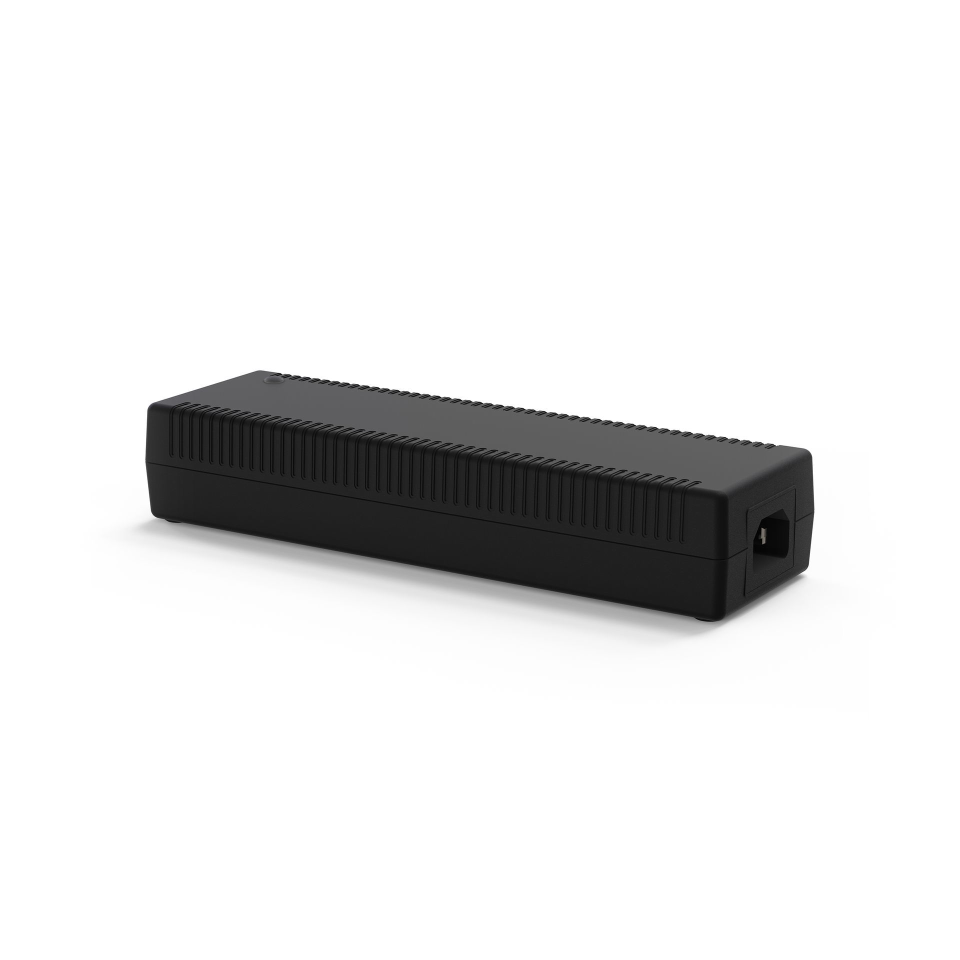 A black power supply is sitting on a white surface