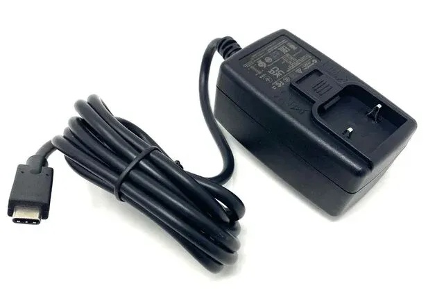 A black power supply is sitting on a white surface