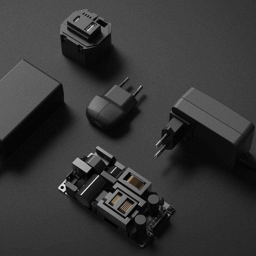 black power supplies are laying on a black surface