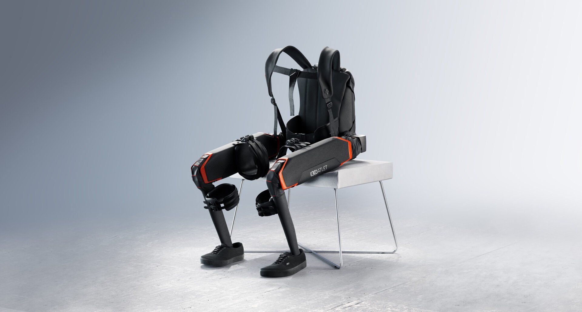 A robot exoskeleton is sitting on a chair with a backpack on it.