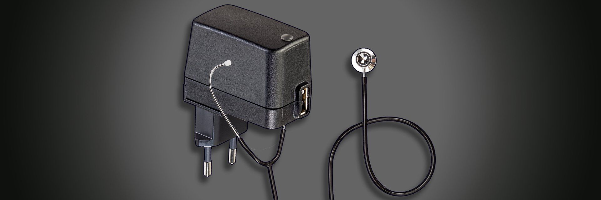 A black power supply with a stethoscope attached to it
