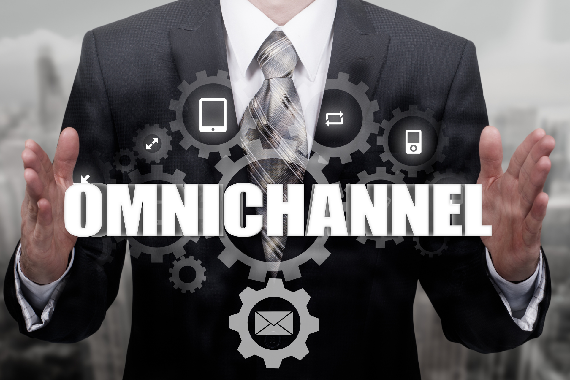 A man in a suit and tie is holding up the word omnichannel