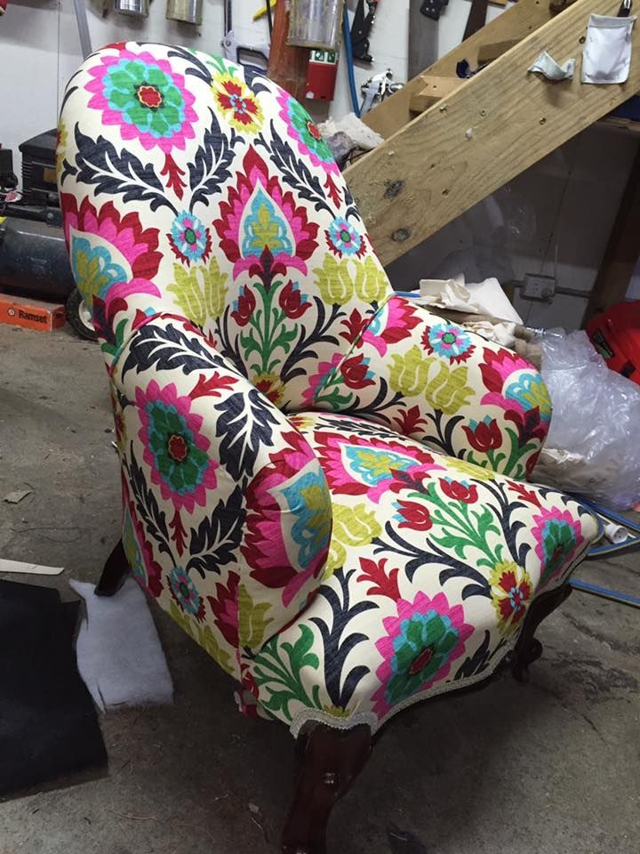 A Chair With a Colorful Floral Pattern is Sitting in a Room — Aztak Upholstery In Manunda, QLD