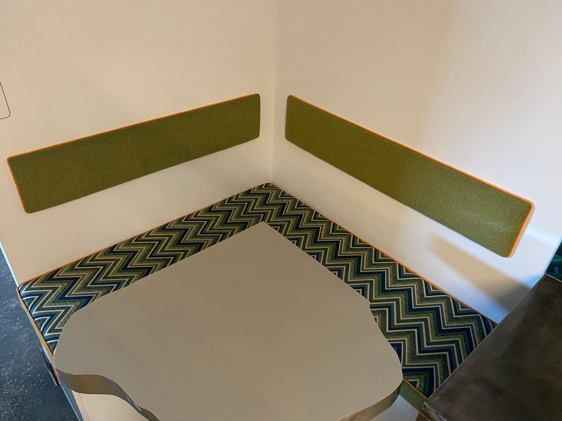 A Green Couch With A Wooden Arm Rest Is Sitting On A Table — Aztak Upholstery In Manunda, QLD