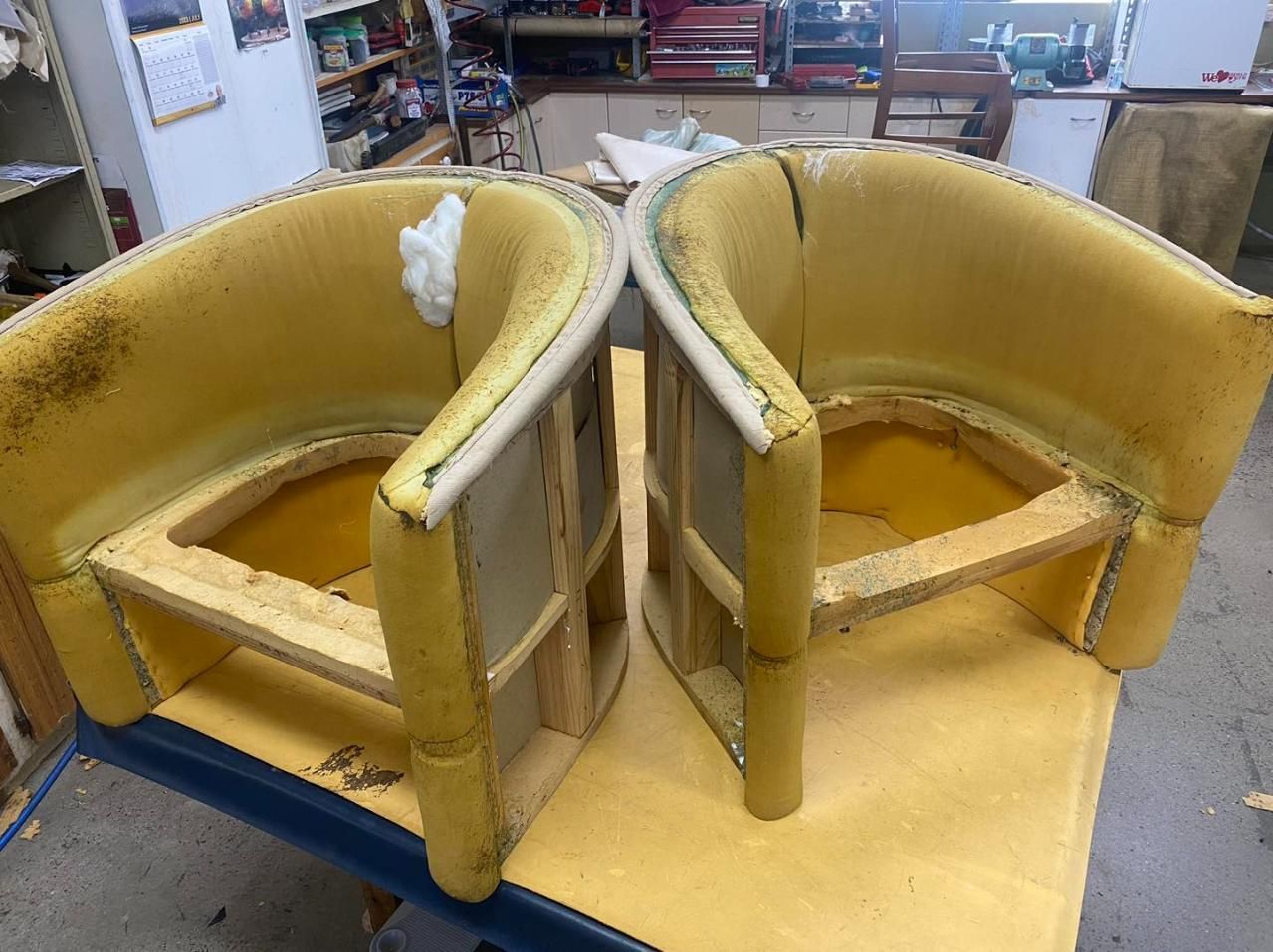 Two Chairs Are Sitting On Top Of A Table In A Workshop — Aztak Upholstery In Manunda, QLD